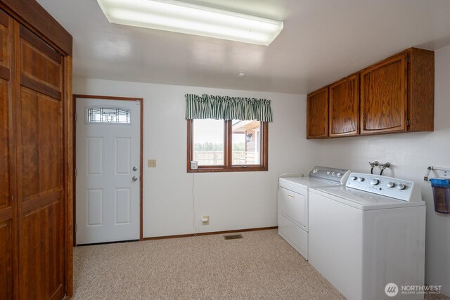 710 S Mckinney Rd, Othello, WA 99344 - laundry room with cabinet space, washing machine and clothes dryer, light carpet, and baseboards