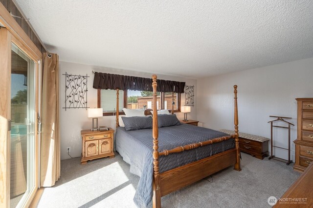 710 S Mckinney Rd, Othello, WA 99344 - carpeted bedroom featuring a textured ceiling
