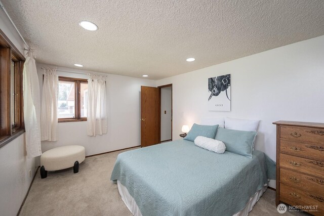 710 S Mckinney Rd, Othello, WA 99344 - bedroom featuring light colored carpet, a textured ceiling, and recessed lighting