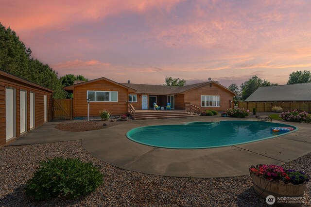 710 S Mckinney Rd, Othello, WA 99344 - pool at dusk with a deck, a gate, and a patio
