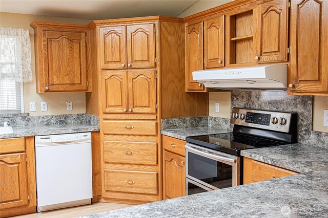 815 NE Karol Loop, College Place, WA 99324 - kitchen with white dishwasher, electric stove, under cabinet range hood, brown cabinets, and light wood-style flooring