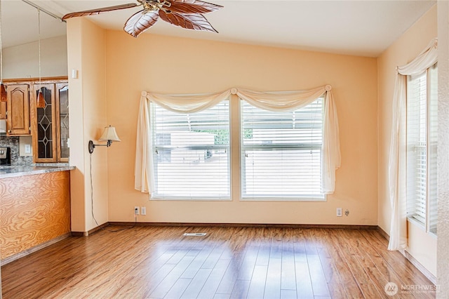 815 NE Karol Loop, College Place, WA 99324 - unfurnished living room featuring light wood finished floors, a ceiling fan, and baseboards