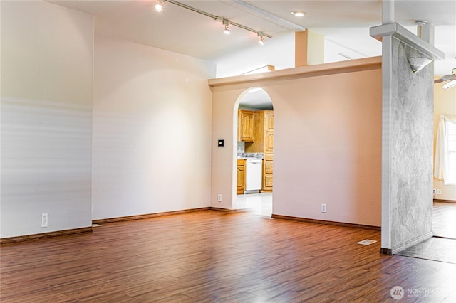 815 NE Karol Loop, College Place, WA 99324 - spare room with track lighting, light wood-style flooring, arched walkways, and baseboards