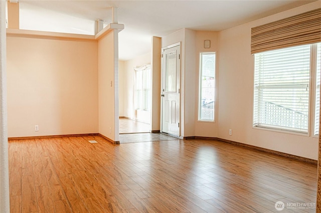 815 NE Karol Loop, College Place, WA 99324 - spare room with healthy amount of natural light, light wood finished floors, and baseboards