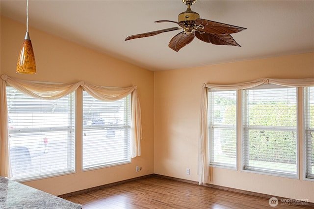 815 NE Karol Loop, College Place, WA 99324 - unfurnished bedroom featuring multiple windows, wood finished floors, and baseboards