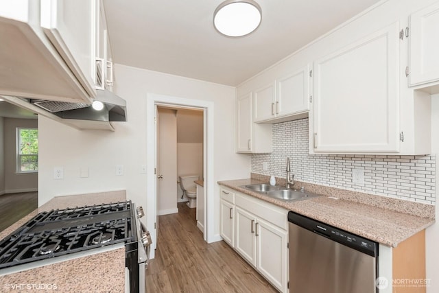 10923 63rd St E, Puyallup, WA 98372 - kitchen with appliances with stainless steel finishes, a sink, backsplash, and light wood-type flooring