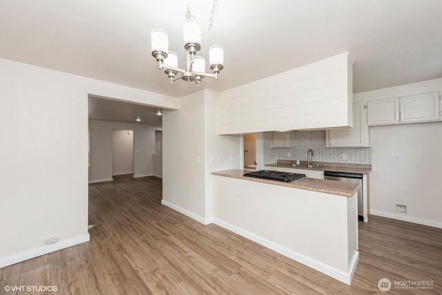 10923 63rd St E, Puyallup, WA 98372 - kitchen with dishwasher, a sink, gas stovetop, tasteful backsplash, and wood finished floors