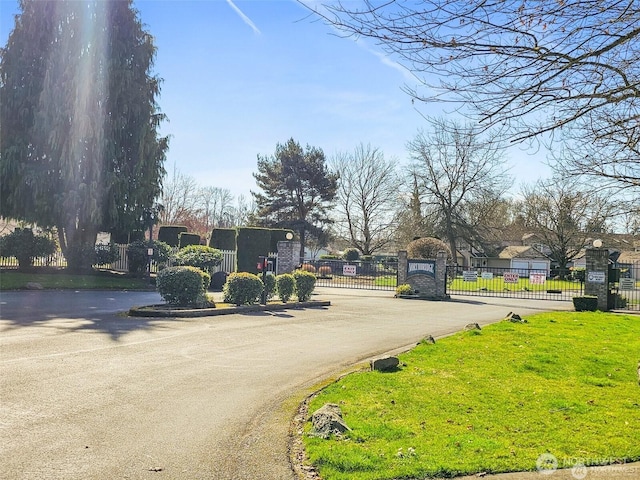 10923 63rd St E, Puyallup, WA 98372 - view of asphalt street featuring a gate, a gated entry, and curbs