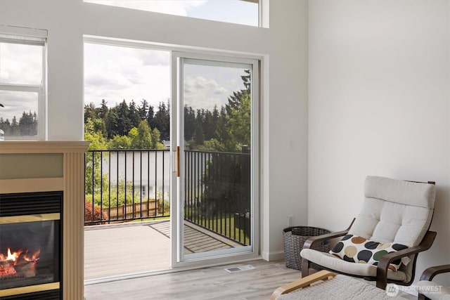 2311 Milton Way Unit E, Milton, WA 98354 - doorway featuring a glass covered fireplace and wood finished floors