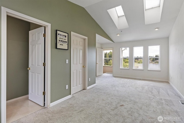 2311 Milton Way Unit E, Milton, WA 98354 - carpeted empty room with a skylight, vaulted ceiling, baseboards, and recessed lighting