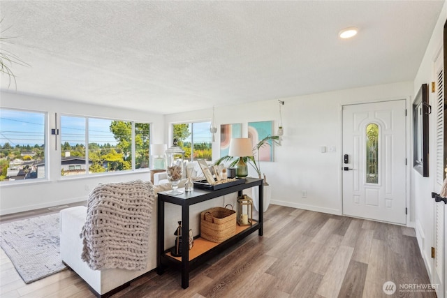 4210 N Vassault St, Tacoma, WA 98407 - foyer entrance featuring a textured ceiling, wood finished floors, baseboards, and recessed lighting