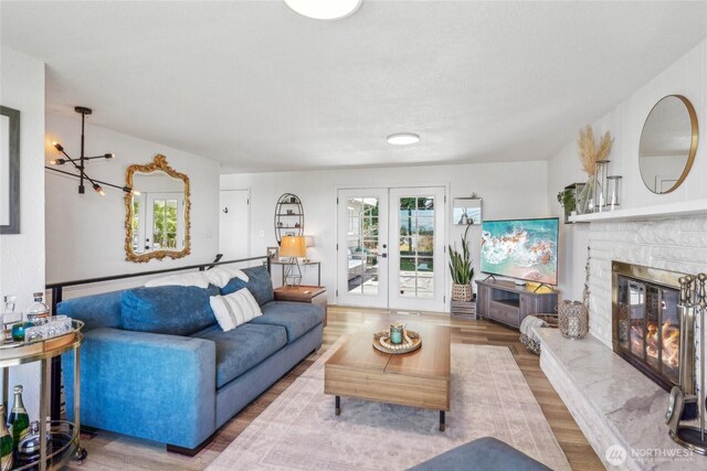 4210 N Vassault St, Tacoma, WA 98407 - living area with plenty of natural light, a fireplace, wood finished floors, and french doors
