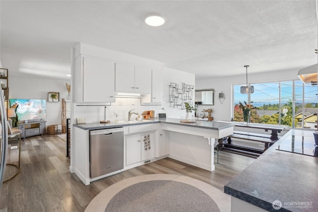 4210 N Vassault St, Tacoma, WA 98407 - kitchen featuring stainless steel dishwasher, wood finished floors, white cabinets, a peninsula, and a sink