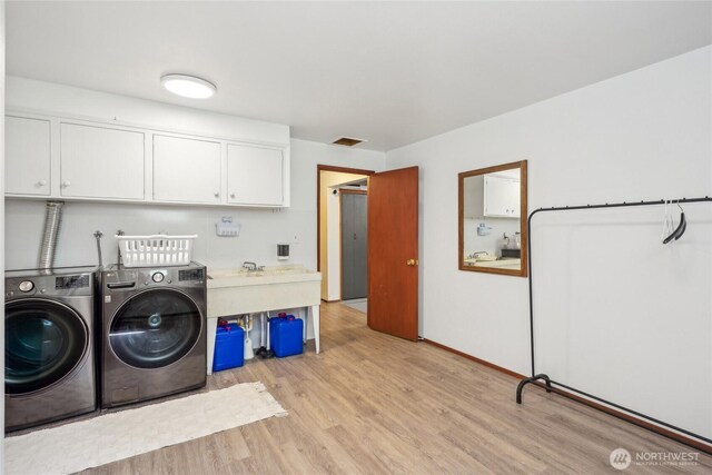 4210 N Vassault St, Tacoma, WA 98407 - washroom featuring cabinet space, independent washer and dryer, and light wood-type flooring