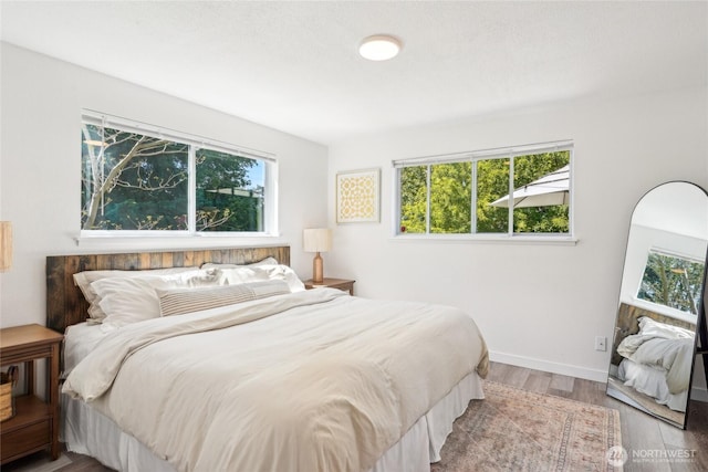 4210 N Vassault St, Tacoma, WA 98407 - bedroom with multiple windows, wood finished floors, and baseboards