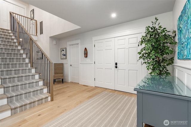 5552 Canvasback Rd, Blaine, WA 98230 - foyer entrance with light wood-style floors, stairway, recessed lighting, wainscoting, and a decorative wall
