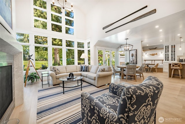 5552 Canvasback Rd, Blaine, WA 98230 - living area featuring a chandelier, healthy amount of natural light, wood finished floors, a towering ceiling, and a fireplace