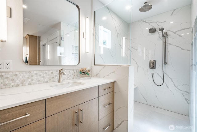 5552 Canvasback Rd, Blaine, WA 98230 - full bathroom featuring vanity, a marble finish shower, backsplash, and tile walls