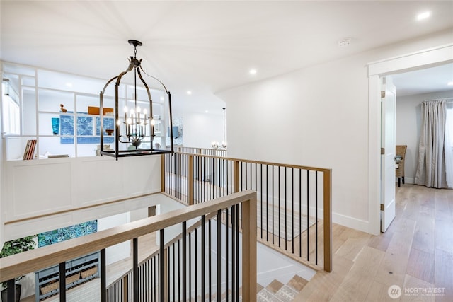 5552 Canvasback Rd, Blaine, WA 98230 - hall featuring a chandelier, an upstairs landing, wood finished floors, baseboards, and recessed lighting