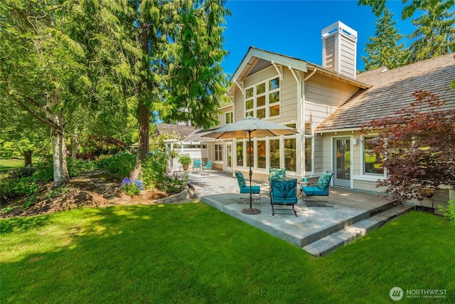 5552 Canvasback Rd, Blaine, WA 98230 - rear view of property with a chimney, a patio area, and a yard