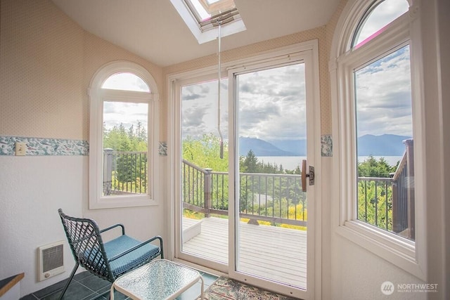 12289 Seabeck Hwy NW, Seabeck, WA 98380 - sunroom / solarium featuring a skylight, vaulted ceiling, a mountain view, and heating unit