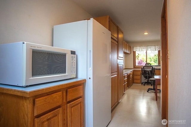 12289 Seabeck Hwy NW, Seabeck, WA 98380 - kitchen with white appliances, brown cabinetry, an office area, and recessed lighting
