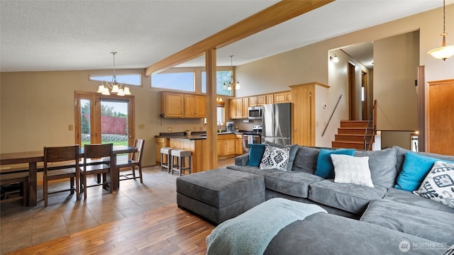 810 E Spring, Dayton, WA 99328 - living area with vaulted ceiling, a chandelier, light wood-type flooring, and stairs