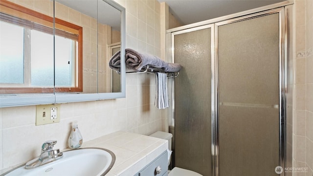 810 E Spring, Dayton, WA 99328 - bathroom with tile walls, a shower stall, vanity, toilet, and backsplash