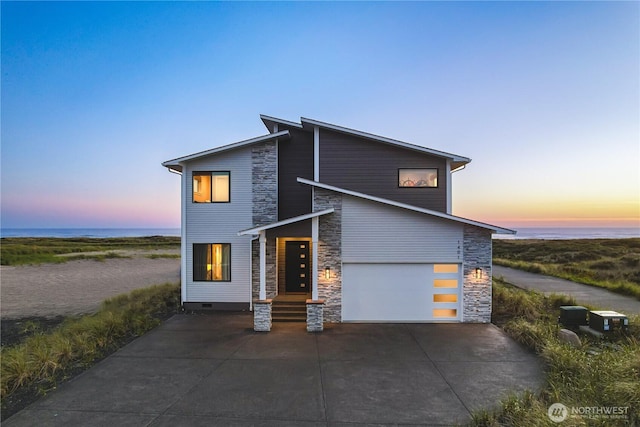 1401 S Cohasset Crst, Westport, WA 98595 - contemporary house featuring stone siding, driveway, a garage, and a water view