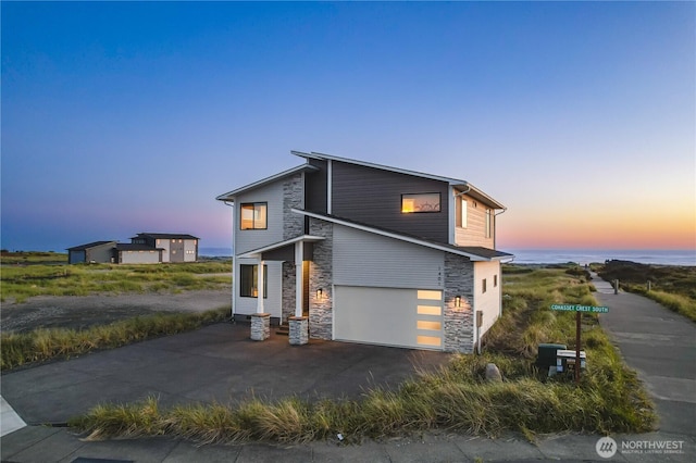 1401 S Cohasset Crst, Westport, WA 98595 - view of front of home with stone siding, asphalt driveway, and a garage