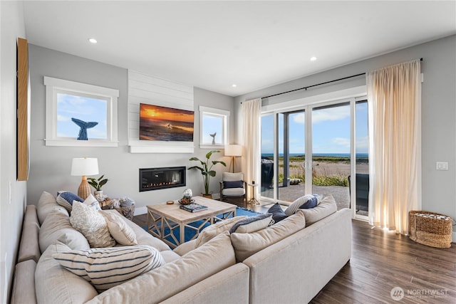 1401 S Cohasset Crst, Westport, WA 98595 - living room featuring a glass covered fireplace, dark wood-style flooring, healthy amount of natural light, and recessed lighting