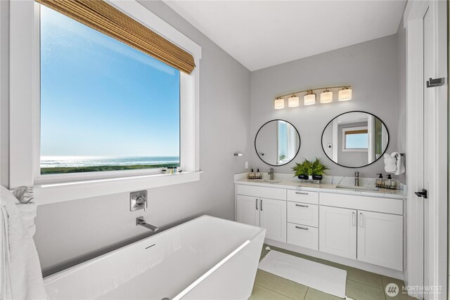 1401 S Cohasset Crst, Westport, WA 98595 - full bathroom with a freestanding bath, double vanity, tile patterned floors, and a water view