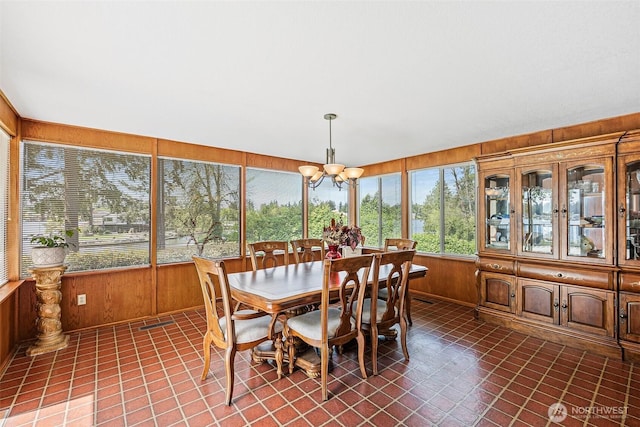 9138 Edgewater Dr SW, Lakewood, WA 98499 - sunroom featuring a chandelier, wood walls, french doors, and tile patterned flooring