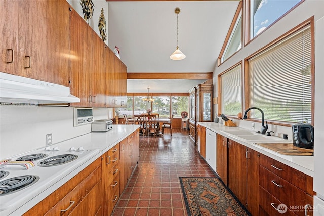 9138 Edgewater Dr SW, Lakewood, WA 98499 - kitchen featuring under cabinet range hood, white appliances, healthy amount of natural light, a sink, and a towering ceiling
