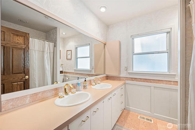 9138 Edgewater Dr SW, Lakewood, WA 98499 - full bath with double vanity, wainscoting, and a shower with shower curtain
