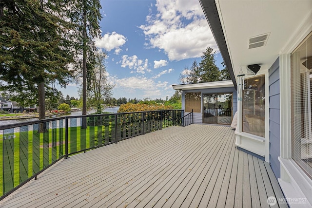 9138 Edgewater Dr SW, Lakewood, WA 98499 - wooden deck with a water view and a lawn