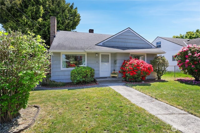 4325 E B St, Tacoma, WA 98404 - bungalow with a chimney, a front lawn, and roof with shingles