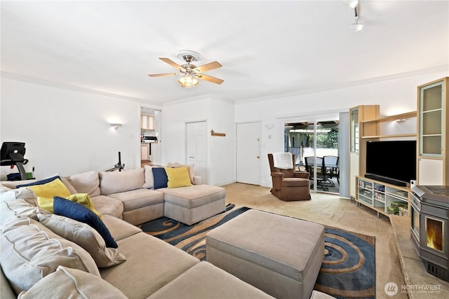4325 E B St, Tacoma, WA 98404 - living room with a ceiling fan, light colored carpet, and a wood stove