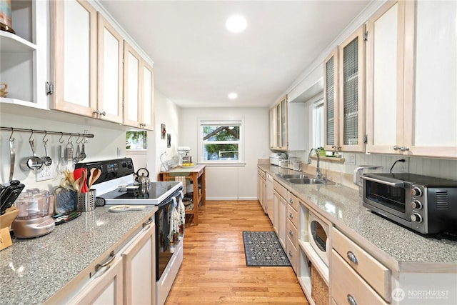 4325 E B St, Tacoma, WA 98404 - kitchen featuring white electric stove, a sink, light wood-type flooring, light countertops, and glass insert cabinets