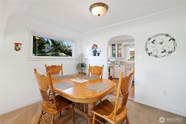 4325 E B St, Tacoma, WA 98404 - dining room with arched walkways, light colored carpet, and baseboards