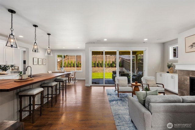 8009 197th Ave E, Bonney Lake, WA 98391 - living room with dark wood-style flooring, recessed lighting, and a tiled fireplace