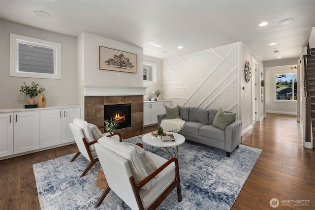 8009 197th Ave E, Bonney Lake, WA 98391 - living area with a tile fireplace, dark wood-style flooring, recessed lighting, and stairs