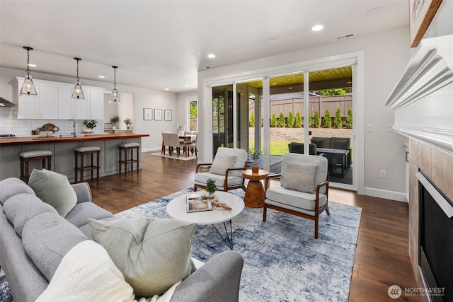 8009 197th Ave E, Bonney Lake, WA 98391 - living room with recessed lighting, dark wood-style floors, and a tile fireplace