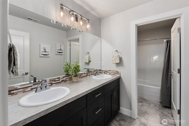 8009 197th Ave E, Bonney Lake, WA 98391 - bathroom featuring double vanity, tasteful backsplash, and shower / bath combo