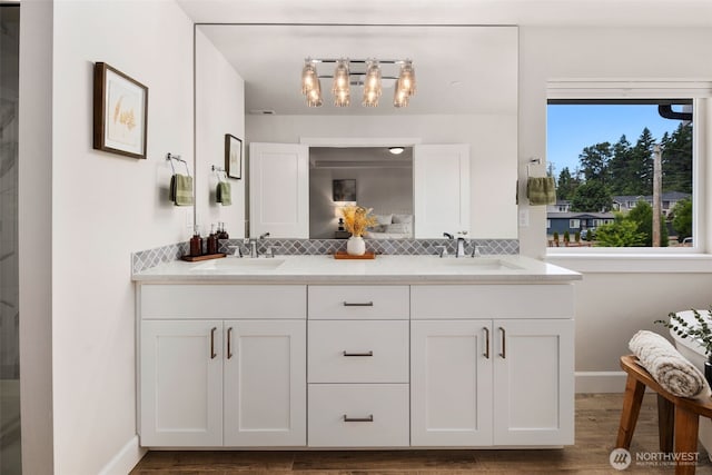 8009 197th Ave E, Bonney Lake, WA 98391 - full bathroom featuring double vanity, decorative backsplash, wood finished floors, and a chandelier
