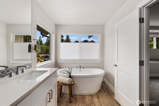 8009 197th Ave E, Bonney Lake, WA 98391 - full bathroom with vanity, wood finished floors, and a freestanding bath
