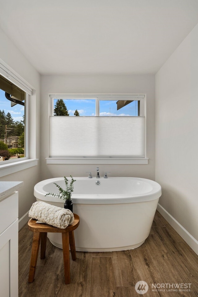 8009 197th Ave E, Bonney Lake, WA 98391 - full bath with a freestanding tub and wood finished floors