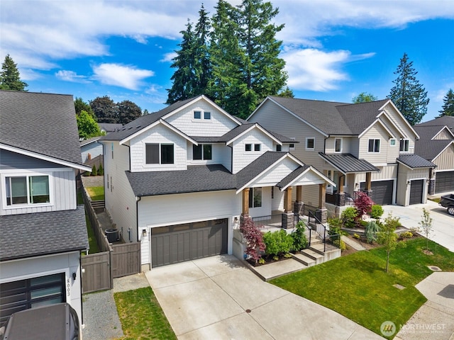 8009 197th Ave E, Bonney Lake, WA 98391 - view of front facade with a garage, concrete driveway, a residential view, a gate, and covered porch