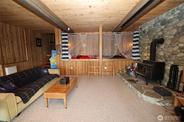209 Marine Dr, Blakely Island, WA 98222 - living room featuring wooden walls, carpet flooring, a wood ceiling with exposed beams, a wood stove, and stairway