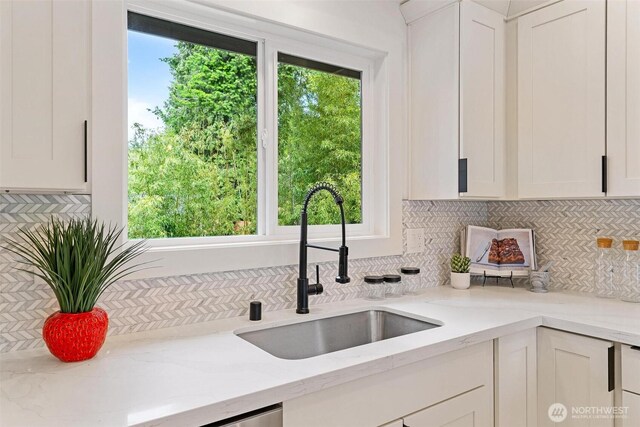 236 S 316th Pl, Federal Way, WA 98003 - kitchen featuring a sink, decorative backsplash, white cabinets, and light stone countertops